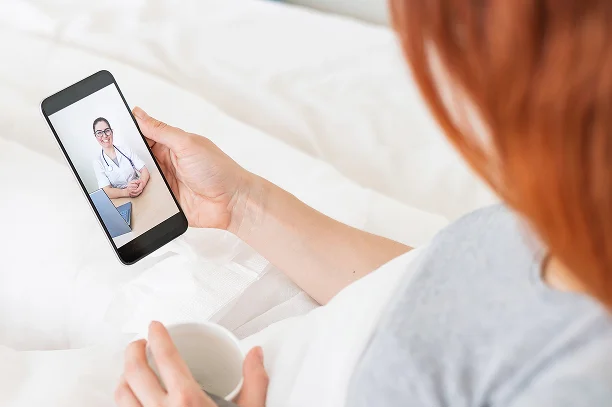Doctor on telehealth consultation via smartphone-hero
