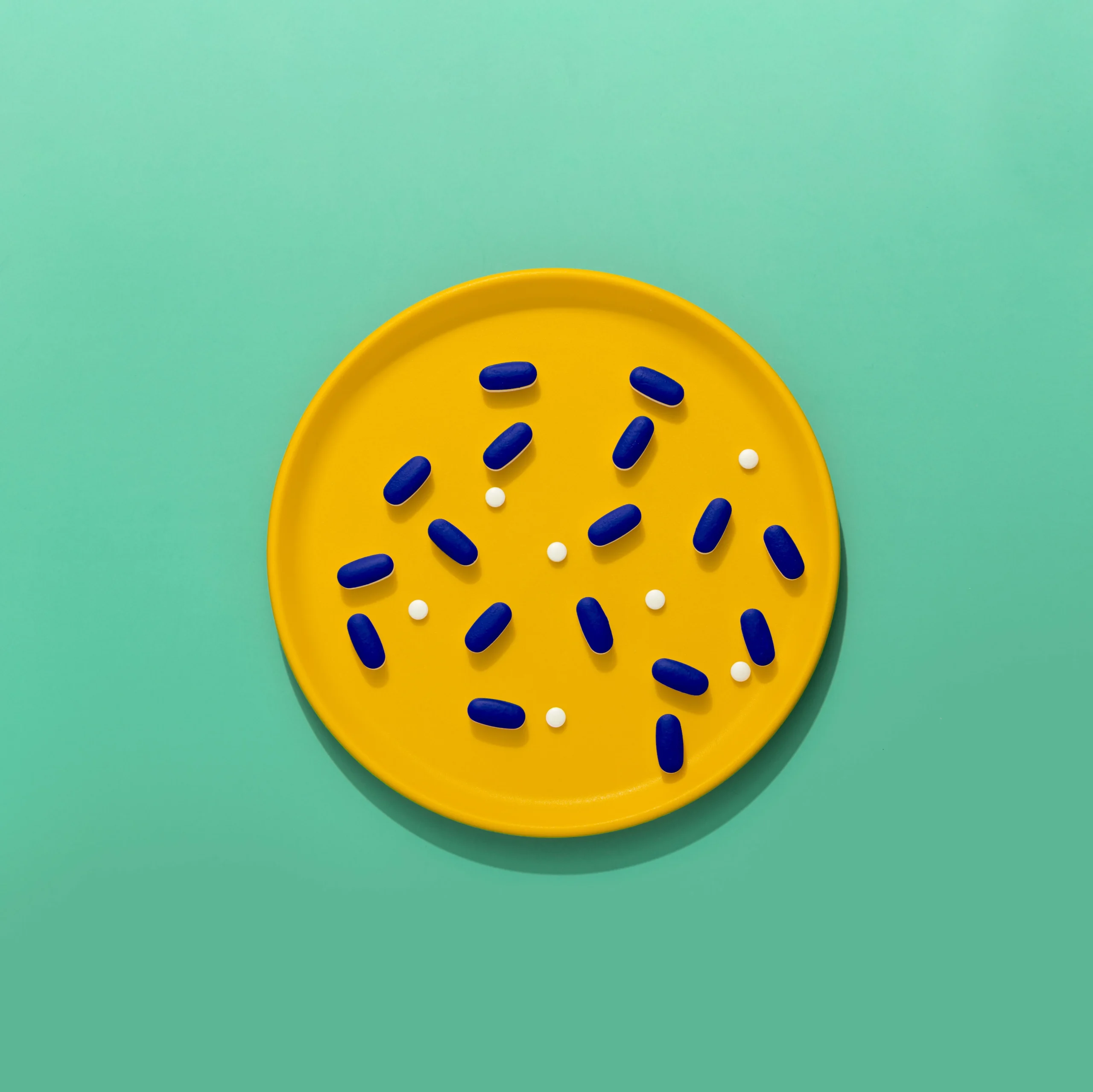 Doxycycline antibiotic capsules and tablets on a yellow tray